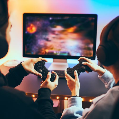 Teens playing video games together.