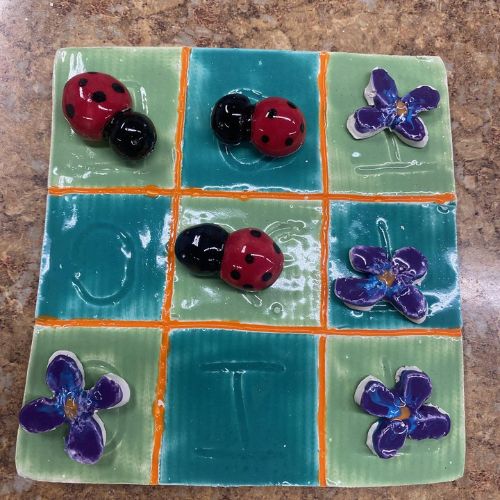 Tic Tac Toe game created using clay and paint at a local pottery store.