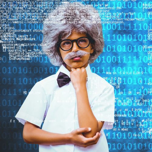 Child with wig and mustache to look like Einstein in front of a large computer screen.