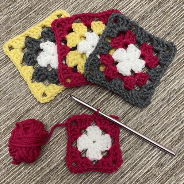 Crochet needle and granny squares